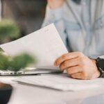 a person holding a paper