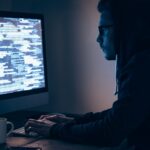 a man sitting at a desk working on a computer