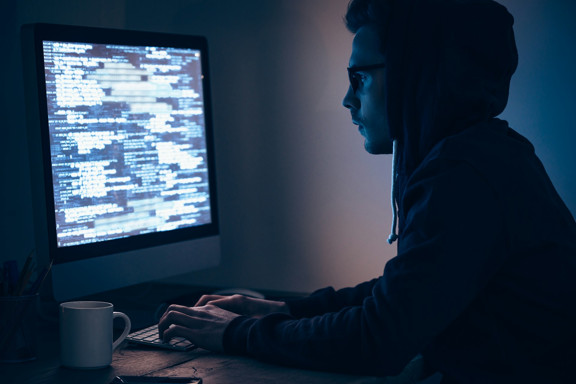 a man sitting at a desk working on a computer